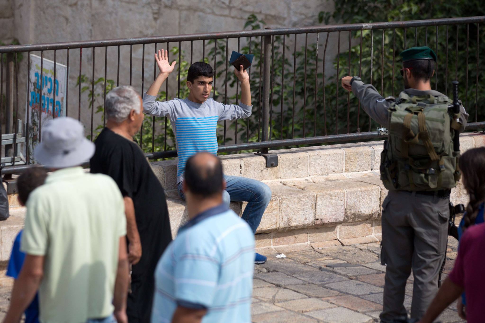A young Palestinian is searched as he attempts to enter the old city in Jerusalem. 