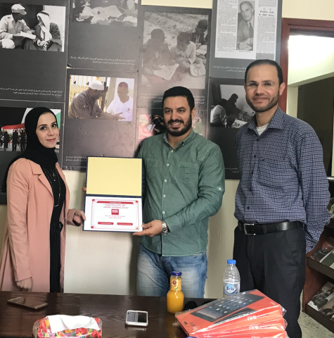 Gaza writer Tarneem Hammad receives award at the Gaza AFSC office.
