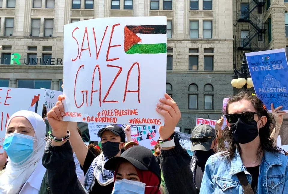 Protester holding a sign that reads "Save Gaza".