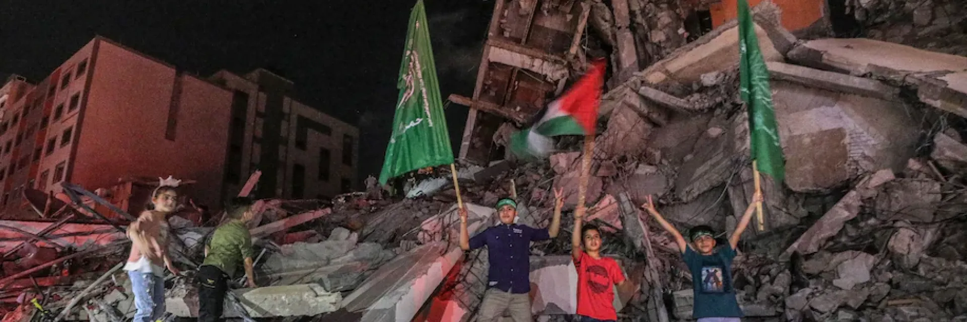 Palestinians celebrate after a cease-fire between Israel and Gaza fighters went into effect early Friday. (Haitham Imad/EPA-EFE/Shutterstock) 